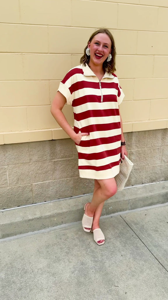 Mini dress with a zippered split-neck collar, cuffed sleeves, and colorblock-style stripes—sporty, stylish, and perfect for Gameday wear.