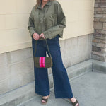 Deep green suede jacket with a classic collar and silver button-front closure