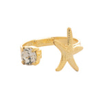 Open-front ring with a starfish and round-cut crystal on gold-tone band.