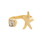 Open-front ring with a starfish and round-cut crystal on gold-tone band.