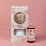Sweet Grace flower diffuser set with packaging on a pink background