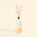 White and gold holiday reed diffuser with reeds