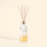 White and gold holiday reed diffuser with reeds